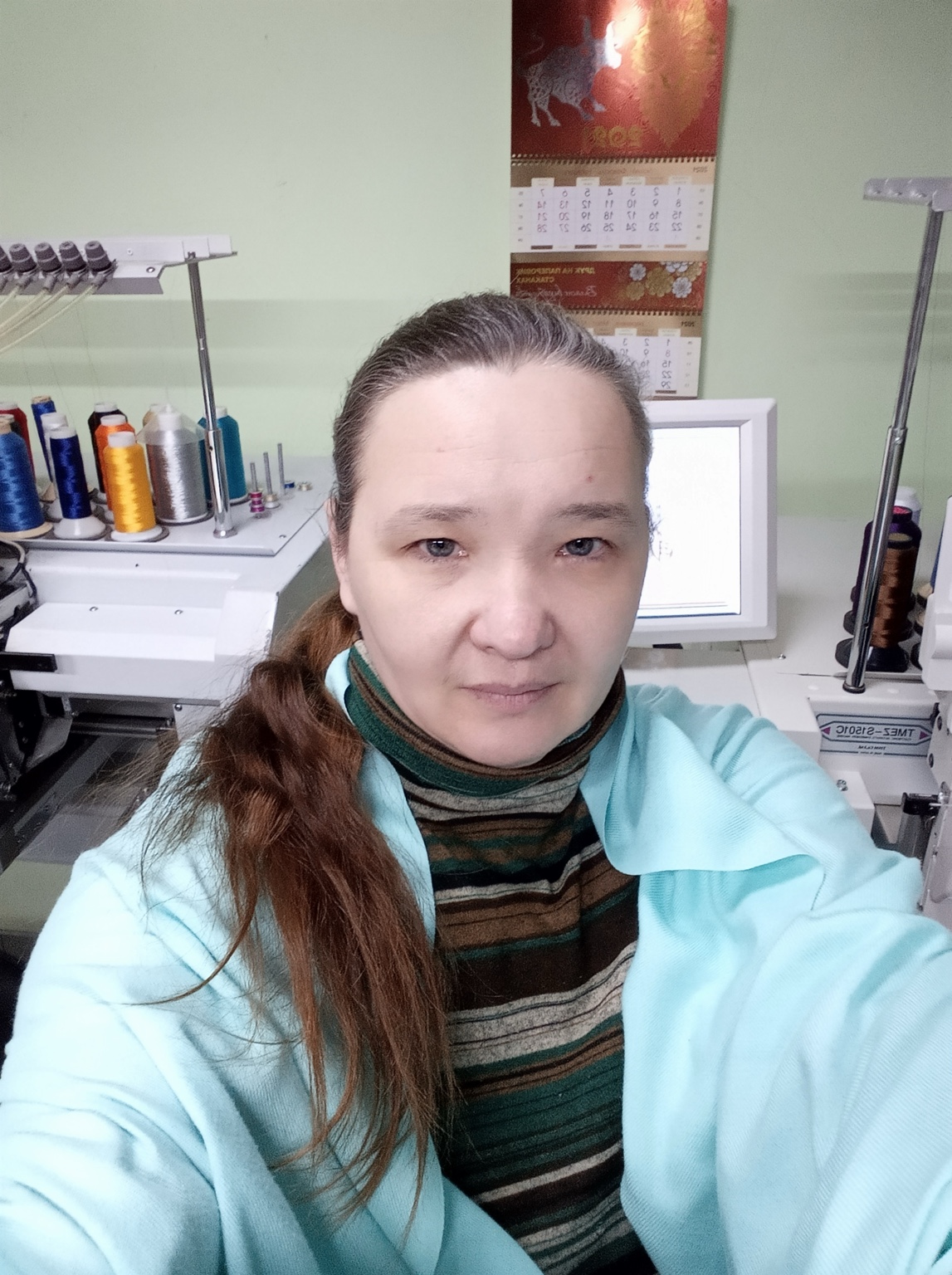 Iryna, embroidery digitizer, at work in her studio